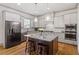 Bright kitchen with stainless steel appliances, kitchen island and bar stool seating at 122 Swansboro Ln, Chapel Hill, NC 27516