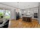 Spacious open kitchen with stainless steel appliances, island and light grey cabinets at 122 Swansboro Ln, Chapel Hill, NC 27516