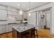 Well-lit kitchen with stainless steel appliances, tile backsplash and granite countertop island at 122 Swansboro Ln, Chapel Hill, NC 27516