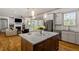 Open kitchen with stainless steel appliances and island open to living area at 122 Swansboro Ln, Chapel Hill, NC 27516