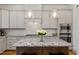Modern kitchen with tile backsplash, stainless steel appliances, and granite countertop island at 122 Swansboro Ln, Chapel Hill, NC 27516