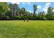 Spacious green lawn perfect for outdoor activities or enjoying nature at 122 Swansboro Ln, Chapel Hill, NC 27516