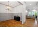 Bright living room featuring hardwood floors and view into Gathering room and dining space at 122 Swansboro Ln, Chapel Hill, NC 27516