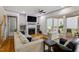 Comfortable living room featuring a fireplace, built-in shelves and hardwood floors at 122 Swansboro Ln, Chapel Hill, NC 27516