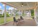 Outdoor porch with seating, wooden floor, beadboard ceiling and neighborhood view at 122 Swansboro Ln, Chapel Hill, NC 27516