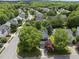 Aerial view of suburban homes with mature trees and well-manicured lawns at 12501 Garden Tree Ln, Raleigh, NC 27614