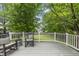 Relaxing back deck with rocking chairs, providing a serene outdoor living space overlooking the yard at 12501 Garden Tree Ln, Raleigh, NC 27614