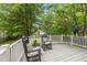 Cozy back deck with rocking chairs and a peaceful view of the lush backyard at 12501 Garden Tree Ln, Raleigh, NC 27614
