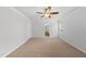 Bedroom with neutral carpet, ceiling fan, and view into the en-suite bathroom at 12501 Garden Tree Ln, Raleigh, NC 27614