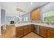 Modern kitchen with stainless steel dishwasher and white countertops, adjoining to the living room at 12501 Garden Tree Ln, Raleigh, NC 27614