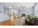 Inviting living room with a fireplace, hardwood floors, and ample seating, bathed in soft, natural light at 12501 Garden Tree Ln, Raleigh, NC 27614