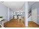 Open-concept living room with hardwood floors, fireplace, and natural light at 12501 Garden Tree Ln, Raleigh, NC 27614