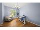 Bright home office with a modern desk, comfortable seating, hardwood floors, and plenty of natural light at 12501 Garden Tree Ln, Raleigh, NC 27614