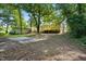 The backyard features a wooden deck, storage building, and mature trees creating a private outdoor space at 1392 L Cooper Rd, Cameron, NC 28326