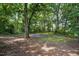 The backyard with mature trees and an open area at 1392 L Cooper Rd, Cameron, NC 28326