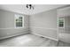 This bedroom includes wood grain flooring, paneled walls, and a large window at 1392 L Cooper Rd, Cameron, NC 28326