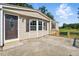 Home exterior showcasing tan siding, a concrete patio, and a decorative front door at 1392 L Cooper Rd, Cameron, NC 28326