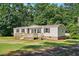 Charming home featuring a spacious wooden deck, neutral siding and neatly landscaped surroundings at 1392 L Cooper Rd, Cameron, NC 28326