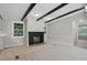 Bright living room includes a black fireplace, plush carpeting, and neutral paint scheme at 1392 L Cooper Rd, Cameron, NC 28326