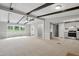 Open living space flows to kitchen, providing views of the front yard from the large windows at 1392 L Cooper Rd, Cameron, NC 28326