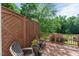 Relax on the outdoor porch featuring comfortable seating, lush greenery, and a privacy lattice at 1404 Kings Lassiter Way, Raleigh, NC 27614