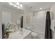 Well-lit bathroom featuring a shower-tub combo, a clean vanity, and a decorative mirror at 1404 Kings Lassiter Way, Raleigh, NC 27614