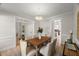 Elegant dining room features a wood table, upholstered chairs, chandelier, and hardwood floors at 1404 Kings Lassiter Way, Raleigh, NC 27614