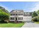 Charming two-story home with a well-manicured front yard, a brick walkway, and a two-car garage at 1404 Kings Lassiter Way, Raleigh, NC 27614