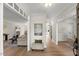 Spacious foyer with hardwood floors, neutral walls, an ottoman, and a view of the living room at 1404 Kings Lassiter Way, Raleigh, NC 27614
