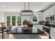 Bright kitchen features granite countertops, stainless appliances, large windows, and an island with seating at 1404 Kings Lassiter Way, Raleigh, NC 27614