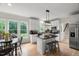 Bright kitchen features granite countertops, stainless appliances, large windows, and an island with seating at 1404 Kings Lassiter Way, Raleigh, NC 27614