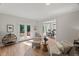Cozy sitting room with hardwood floors, neutral furniture, and access to the back patio at 1404 Kings Lassiter Way, Raleigh, NC 27614