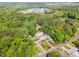 Scenic aerial view showcases the house surrounded by verdant trees and manicured lawns at 1408 Old Ivey Rd, Apex, NC 27523