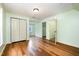 Attic featuring hardwood floors, light green paint, a closet, and doorway to another room at 1408 Old Ivey Rd, Apex, NC 27523
