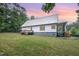 Expansive backyard featuring a metal roof, deck, and lush lawn, providing ample outdoor space at 1408 Old Ivey Rd, Apex, NC 27523
