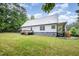 Expansive backyard featuring a metal roof, deck, and lush lawn, providing ample outdoor space at 1408 Old Ivey Rd, Apex, NC 27523