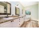 Bathroom with dual sinks, granite counters, new cabinets, and a soaking tub next to a window at 1408 Old Ivey Rd, Apex, NC 27523