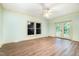 Bedroom with neutral walls, wood flooring, base molding, windows and french doors at 1408 Old Ivey Rd, Apex, NC 27523