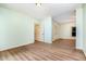 Bedroom with neutral walls, wood flooring, base molding, and two entry doors at 1408 Old Ivey Rd, Apex, NC 27523