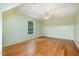 Bedroom featuring hardwood floors, a window, and light mint green paint at 1408 Old Ivey Rd, Apex, NC 27523