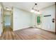 Bright dining area with hardwood floors, a modern light fixture, and a door leading to the backyard at 1408 Old Ivey Rd, Apex, NC 27523