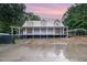 Charming home featuring a metal roof, covered porch, and large driveway perfect for country living at 1408 Old Ivey Rd, Apex, NC 27523