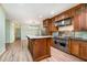 Kitchen features custom wood cabinets, stainless steel appliances and eat in island with quartz countertops at 1408 Old Ivey Rd, Apex, NC 27523