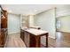 Kitchen features custom wood cabinets, stainless steel appliances and eat in island with quartz countertops at 1408 Old Ivey Rd, Apex, NC 27523