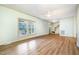 Bright living room with hardwood floors, large windows, and a ceiling fan, perfect for relaxation at 1408 Old Ivey Rd, Apex, NC 27523