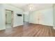 View of light filled living room featuring wood floors, fan, and access to other parts of the house at 1408 Old Ivey Rd, Apex, NC 27523