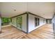 Spacious covered porch featuring wood floors and ample space for relaxing or entertaining outdoors at 1408 Old Ivey Rd, Apex, NC 27523