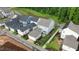 Aerial view of the home showcasing its backyard, landscaping, patio, and surrounding neighborhood at 1423 Tannin Dr, Durham, NC 27713