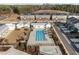 Aerial view featuring a community pool and townhouse-style homes at 1423 Tannin Dr, Durham, NC 27713