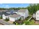 Aerial view of the home showcasing the fenced backyard, patio, detached garage, and well-manicured landscaping at 1423 Tannin Dr, Durham, NC 27713